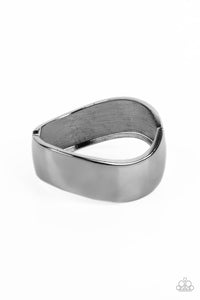A thick band of gunmetal wraps around the wrist in a dramatic display. As the edges of the band curve into subtle waves, the high sheen finish creates a blinding display of intense sheen that demands attention. Features a hinged closure.  Sold as one individual bracelet.