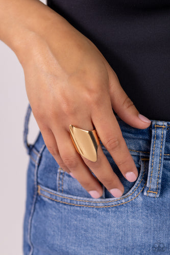 A thick band of glistening gold arcs across the finger, with two sharp points jutting out at the ends, coalescing into a bold, asymmetrical centerpiece. Features a stretchy band for a flexible fit.  Sold as one individual ring.