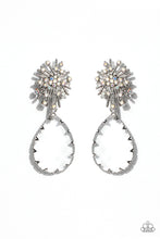 Load image into Gallery viewer, An explosion of radiating silver bars is topped with a sprinkle of iridescent rhinestones, creating a stellar anchoring point. Swinging below the starburst, an oversized, clear teardrop with a light-catching, faceted surface is wrapped in a textured border of silver, adding stunning dimension and refinement to the cosmic combination. Earring attaches to a standard post fitting. Due to its prismatic palette, color may vary.  Sold as one pair of post earrings.
