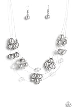 Load image into Gallery viewer, Strung along a trio of delicate silver wires, an ethereal collection of white crystal-like gems, clear faceted beads, and timeless gray pearls are pressed into teardrop, oval, and circular frames as they cluster along the collar. The mismatched clusters of sparkle and refinement seemingly float across the neckline, emitting an air of effortless elegance. Features an adjustable clasp closure.  Sold as one individual necklace. Includes one pair of matching earrings.
