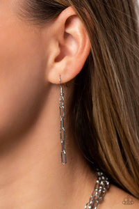 Silver oval links hanging from a silver fish hook earring.