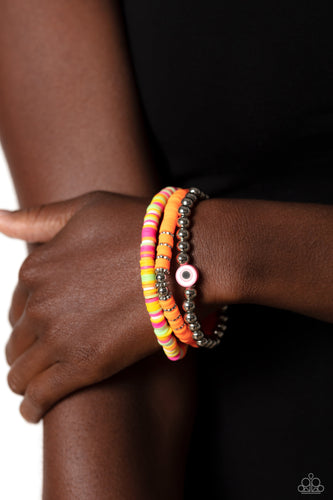 Varying in colorful shades, orange, pink, green, white, and yellow rubber discs pair with shiny silver beads and silver accents creating colorful layers across the wrist. Featured on the silver-beaded bracelet, a rubber shape with an eye-like design contributes an additional shade of pink to the design.  Sold as one set of three bracelets.