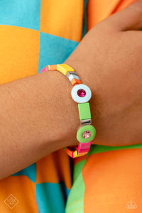 Alternating along the wrist in a whimsically colorful pattern, a collection of stacked silver cube beads, and multicolored metallic squares are threaded along an elastic stretchy band. Three circular frames, in Pantone® shades of Classic Green, Summer Song, and Fuchsia Fedora, haphazardly interrupt the cubed beading, showcasing their colorful rhinestone centers for additional contrast around the wrist.