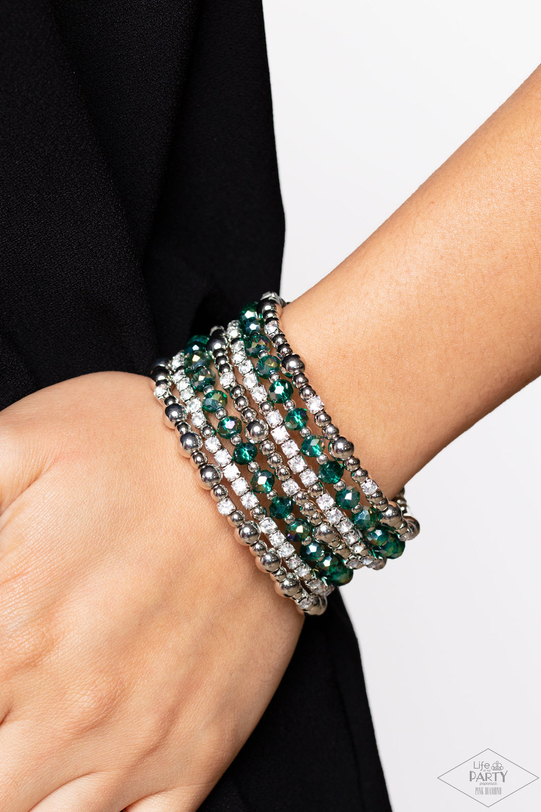 An icy collection of silver beads, cubes, opaque green crystals with an iridescent shimmer, and glassy white rhinestones are threaded along a coiled wire, creating a blinding infinity wrap style bracelet around the wrist. Due to its prismatic palette, color may vary.  Sold as one individual bracelet.