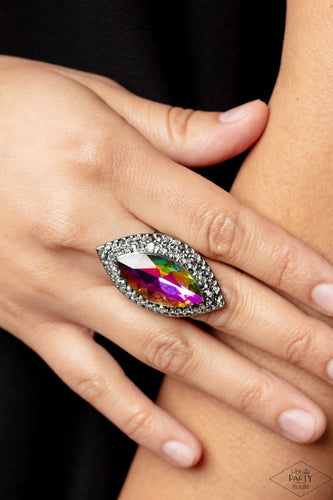 Featuring a UV shimmer, a dramatic gem is pressed into the center of stacking gunmetal frames encrusted in row after row of hematite rhinestones for a blinding look. Features a stretchy band for a flexible fit. Due to its prismatic palette, color may vary.  Sold as one individual ring.
