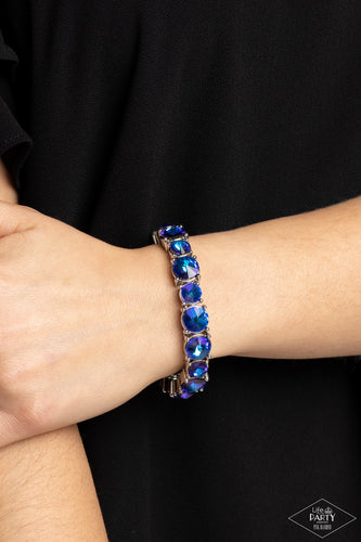 An assortment of oversized blue oil spill rhinestones are pressed into silver frames and threaded along stretchy bands, creating a blinding sparkle around the wrist. Due to its prismatic palette, color may vary. Sold as one individual bracelet.
