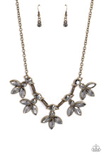 Load image into Gallery viewer, ﻿Featuring smoldering marquise style cuts, oversized smoky gems fan out from an interconnected, circular smoky rhinestone display. Separating the dauntless florals, airy brass ovals, stamped with a dot motif, create additional eye-catching sheen. Features an adjustable clasp closure.  Sold as one individual necklace. Includes one pair of matching earrings.
