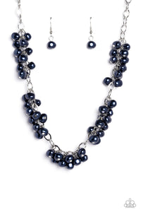 A cascade of Montana Blue pearly beads dangle from a high-sheen silver, oval linked chain. The pearly beads cluster across the neckline, creating a refined pop of color. Features an adjustable clasp closure.  Sold as one individual necklace. Includes one pair of matching earrings.