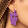 Load image into Gallery viewer, Asymmetrical, oversized purple petals bloom into an abstract flower hoop for a fashionable, attention-grabbing pop of color around the ear. Earring attaches to a standard post fitting. Hoop measures approximately 2&quot; in diameter.  Sold as one pair of hoop earrings.
