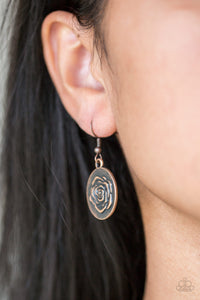 Embossed in a whimsical rosebud pattern, a shimmery copper frame swings from a copper fish hook earring.