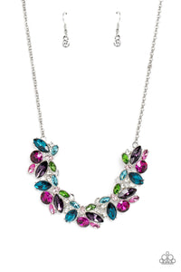 Featuring pronged silver fittings, a sparkly series of marquise-cut rhinestones in varying sizes and opacities are splashed in hues of purple, blue, light blue, baby pink, pink, and green as they fan out below the collar for a vibrant statement. Fuchsia and white round gems in varying sizes sporadically cluster around the marquise-cuts for additional shimmer in the geometric, refined display.  Sold as one individual necklace. Includes one pair of matching earrings.