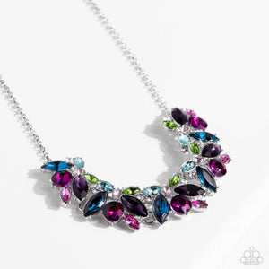 Featuring pronged silver fittings, a sparkly series of marquise-cut rhinestones in varying sizes and opacities are splashed in hues of purple, blue, light blue, baby pink, pink, and green as they fan out below the collar for a vibrant statement. Fuchsia and white round gems in varying sizes sporadically cluster around the marquise-cuts for additional shimmer in the geometric, refined display.  Sold as one individual necklace. Includes one pair of matching earrings.