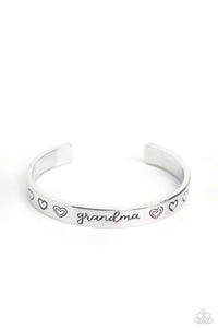 Brushed in a polished sheen, a skinny silver bar curls around the wrist, creating a rustic cuff. Featuring a heart motif, the skinny cuff is engraved with the word “grandma” with various styles of hearts framing the word for an inspiring, heartfelt finish.  Sold as one individual bracelet.