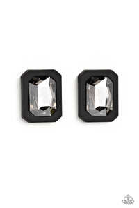 Standing out against a black rubber backdrop, an oversized, faceted emerald-cut gem shimmers and shines for an edgy sparkle against the ear. Earring attaches to a standard post fitting.  Sold as one pair of post earrings.