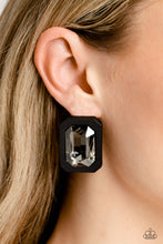Load image into Gallery viewer, Standing out against a black rubber backdrop, an oversized, faceted emerald-cut gem shimmers and shines for an edgy sparkle against the ear. Earring attaches to a standard post fitting.  Sold as one pair of post earrings.

