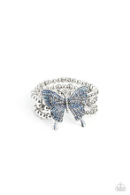 Load image into Gallery viewer, Strung along elastic stretchy bands, a trio of silver and textured silver beads and accents wrap around the wrist. Featured atop the beaded collection, an oversized silver butterfly, with intricate details, is sprinkled with dainty blue iridescent rhinestones across its wings and body, for a dramatically dazzling finish. Due to its prismatic palette, color may vary.  Sold as one individual bracelet.
