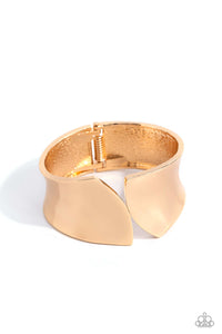 A thick band of high-sheen gold, with its edges seemingly sheared off, creates a sharp, edgy cuff-like bracelet around the wrist. Features a hinged closure.  Sold as one individual bracelet.