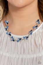 Load image into Gallery viewer, An eclectic collection of white and blue round rhinestones in varying sizes and marquise-cut gems in a blue shade cluster around the collar in high-sheen silver frames. Patterned in an abstract manner, the clusters interlock together, emitting light from every faceted angle. Features an adjustable clasp closure. Includes one pair of matching earrings.
