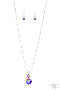 Nestled inside classic silver prongs, two oversized rhinestones, featuring a UV shimmer, slide along a dainty silver snake chain, creating a dramatic pendant below the collar. Features an adjustable clasp closure.  Sold as one individual necklace. Includes one pair of matching earrings.