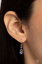 Load image into Gallery viewer, Nestled inside classic silver prongs, two oversized rhinestones, featuring a UV shimmer, slide along a dainty silver snake chain, creating a dramatic pendant below the collar. Features an adjustable clasp closure.  Sold as one individual necklace. Includes one pair of matching earrings.
