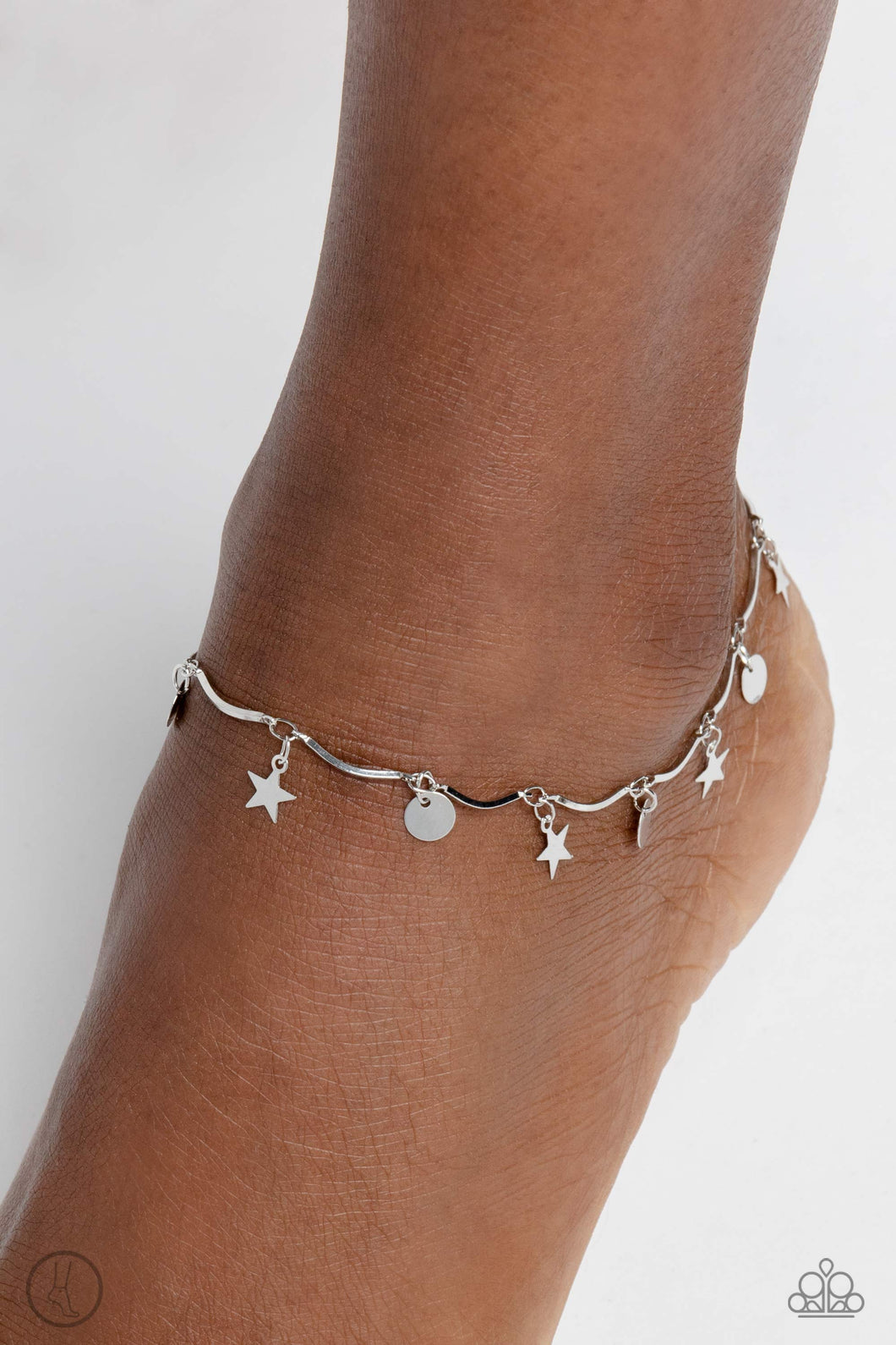 A fringe of sleek silver stars and discs swings from a dainty silver overlay chain, creating whimsical movement around the ankle. Features an adjustable clasp closure.  Sold as one individual anklet.