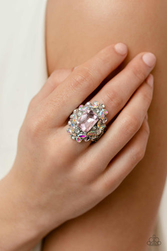 A faceted radiant-cut pink gem is pressed into an elaborate frame filled with blinding round, teardrop and marquise-cut gems in shades of white, pink, and iridescent for a blingy statement atop the finger. Features a stretchy band for a flexible fit. Due to its prismatic palette, color may vary.  Sold as one individual ring.