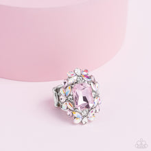 Load image into Gallery viewer, A faceted radiant-cut pink gem is pressed into an elaborate frame filled with blinding round, teardrop and marquise-cut gems in shades of white, pink, and iridescent for a blingy statement atop the finger. Features a stretchy band for a flexible fit. Due to its prismatic palette, color may vary.  Sold as one individual ring.
