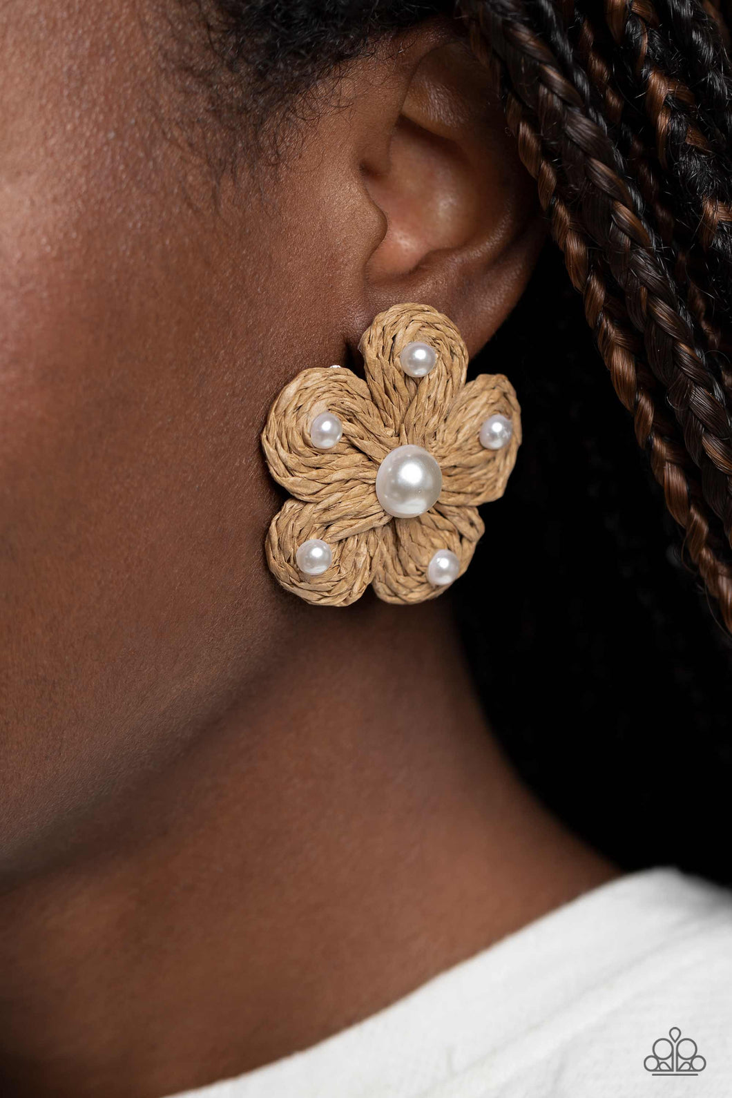 Pearls in varying sizes, sporadically dot the front of a tan straw-like woven floral centerpiece for a beachy flair. Earring attaches to a standard post fitting.  Sold as one pair of post earrings.
