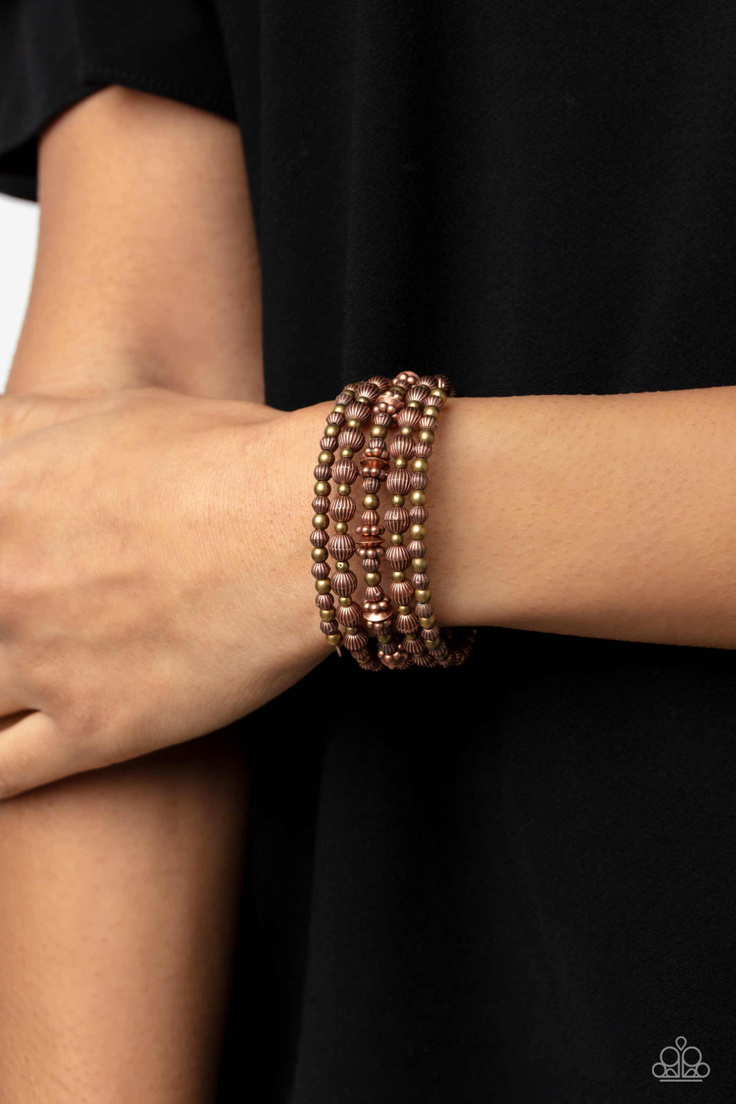 Coiling around the wrist, striped copper beads of varying sizes, interacts with brass accents, copper wheel beads, and copper discs for an eye-catching, endless design.  Sold as one individual bracelet.