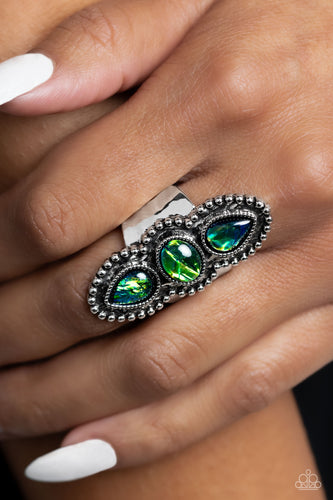 Centered around an elongated, decoratively studded silver frame, two opalescent refracted shimmer green teardrops flank an opalescent green oval, creating a whimsically seasonal statement piece atop the finger. Features a stretchy band for a flexible fit. Due to its prismatic palette, color may vary.  Sold as one individual ring.