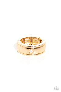 Dotted with a dainty white pearl center, a shiny, sleek gold band stands out against the finger for a sophisticated finish. Features a stretchy band for a flexible fit.  Sold as one individual ring.