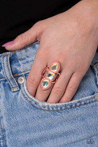 Featuring square and teardrop cuts, vivacious iridescent gems are pressed into a studded and sleek shiny copper frame, creating a stacked, grand display atop the finger. Airy shiny copper bands anchor the blinding bling to the finger for additional whimsical detail. Features a stretchy band for a flexible fit. Due to its prismatic palette, color may vary. Sold as one individual ring.