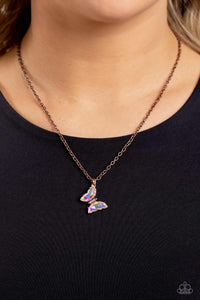 Infused with faceted iridescent gem wings, a copper butterfly pendant swings from a dainty copper chain below the collar for a whimsy flair. Features an adjustable clasp closure.  Sold as one individual necklace. Includes one pair of matching earrings.