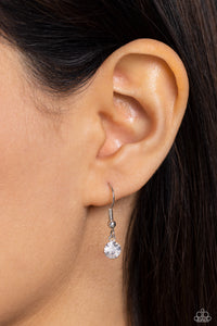 Small rhinestone hanging from a silver fish hook earring.