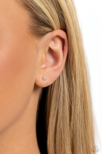 A dainty baby pink pearl rests against the ear for a timeless basic staple piece perfect for a vintage look. Earring attaches to a standard post fitting.  Sold as one pair of post earrings.
