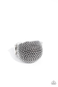 Dotting the surface of an extended silver frame, dainty silver studs seemingly pop off the finger, reflecting light off its every surface for an industrial finish. Features a stretchy band for a flexible fit.  Sold as one individual ring.