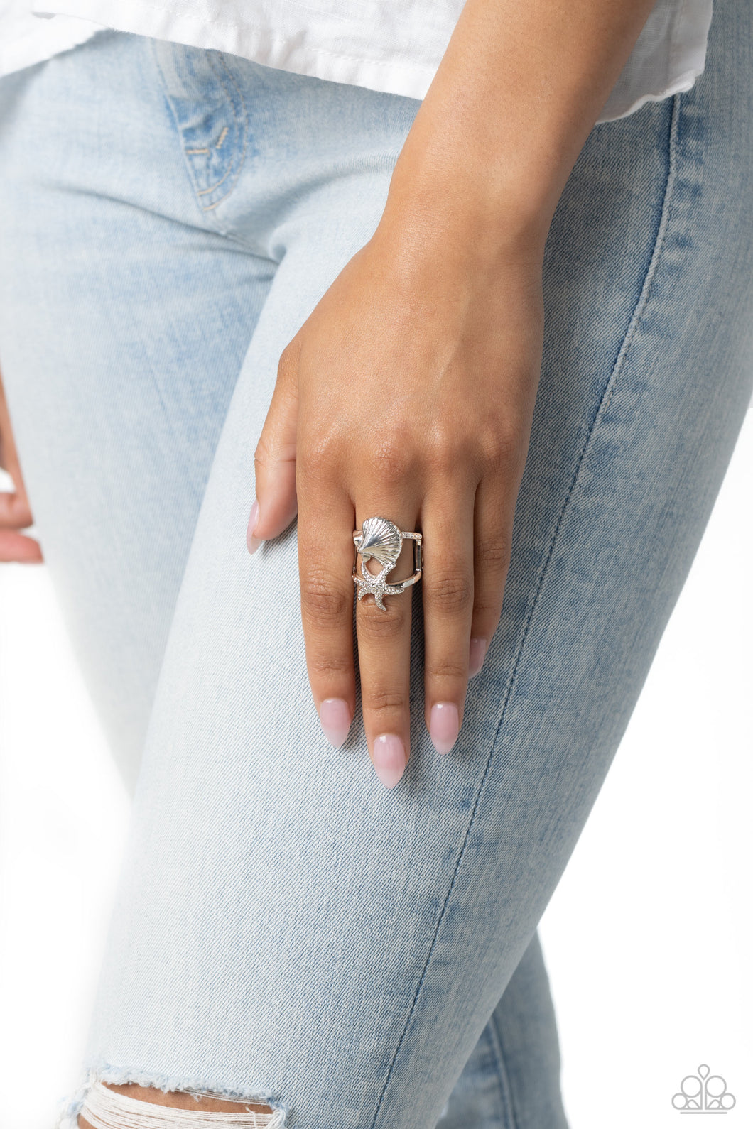 Featuring a layered design, a textured silver seashell crowns the uppermost band of an airy centerpiece, while a studded silver starfish is encrusted along the lowermost band for a beachy look. Features a stretchy band for a flexible fit.  Sold as one individual ring.