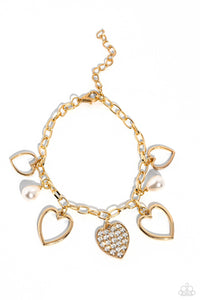 Glistening gold heart silhouettes, white potato pearls, and a white rhinestone-encrusted gold heart frame dangle from a classic gold chain link around the wrist, resulting in a romantic fringe. Features an adjustable clasp closure.  Sold as one individual bracelet,