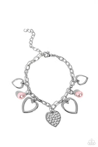 Glistening silver heart silhouettes, baby pink potato pearls, and a white rhinestone-encrusted silver heart frame dangle from a classic silver chain link around the wrist, resulting in a romantic fringe. Features an adjustable clasp closure.  Sold as one individual bracelet.
