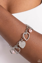 Load image into Gallery viewer, Glistening silver heart silhouettes, baby pink potato pearls, and a white rhinestone-encrusted silver heart frame dangle from a classic silver chain link around the wrist, resulting in a romantic fringe. Features an adjustable clasp closure.  Sold as one individual bracelet.
