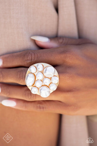 Featuring an array of gleaming baroque pearls in varying sizes, an asymmetrical, oversized gold disc rest atop the finger for a beach-inspired statement. Features a stretchy band for a flexible fit.  Sold as one individual ring.