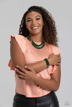 Load image into Gallery viewer, Two rows of oversized emerald green beads featuring a subtle shimmer, silver accents, and clear gray cubed beads fall below the collar on silver paperclip chains, creating refined, colorful layers. Features an adjustable clasp closure. Includes one pair of matching earrings.  The Complete Look! Bracelet: &quot;Shopaholic Showdown - Green&quot;
