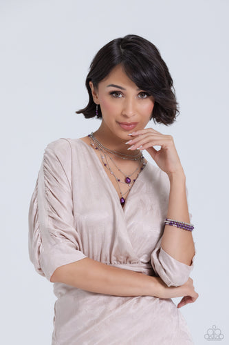 Dainty lavender pearls, silver beads, and plum pearls trickle along an assortment of silver chains, creating shimmery layers across the chest. Two exaggerated plum pearly teardrops cascade from the bottom of the design for additional eye-catching detail. Features an adjustable clasp closure. Includes one pair of matching earrings. An eye-catching infinity wrap style bracelet to match.