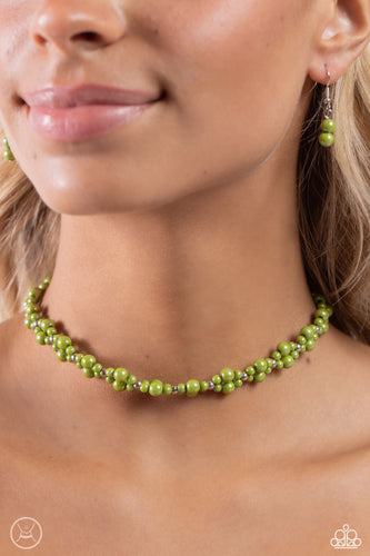 Dipped in an iridescent finish, varying sizes of green pearls cluster around the neckline in a dreamy pop of color. Dainty silver beads alternate along the collar and pearly clusters for a touch of industrial shimmer. Features an adjustable clasp closure. Due to its prismatic palette, color may vary.   Featured inside The Preview at Made for More! Sold as one individual choker necklace. Includes one pair of matching earrings.