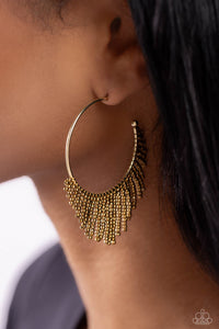 Cascading strands of brass seed beads stream out from the bottom of a classic brass hoop, resulting in a flirtatiously tasseled look. Earring attaches to a standard post fitting. Hoop measures approximately 1 1/2" in diameter.  Sold as one pair of hoop earrings.