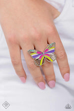 Load image into Gallery viewer, Featuring Fuchsia Fedora, Love Bird, purple, and baby pink details, an oversized, silver butterfly flutters atop airy silver bands. Dainty multicolored and iridescent rhinestones dust the upper curves of the silver wings for a dazzling centerpiece atop the finger. Features a stretchy band for a flexible fit. Due to its prismatic palette, color may vary.  Sold as one individual ring.
