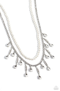 Featuring a white rhinestone square-fitting chain, white teardrop-cut gems, bordered in silver pronged fittings, swing from streams of glittery rhinestones while solitaire teardrop gems drip in an alternating pattern. A strand of gleaming white pearls layers above the silver display for a luxurious finish around the collar. Features an adjustable clasp closure.  Sold as one individual choker necklace. Includes one pair of matching earrings.
