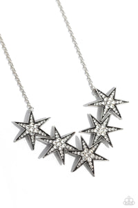 Dotted with various sizes of highly reflective white rhinestones, a stellar collection of 3D silver stars interlock from a dainty silver link chain for an out-of-this-world edgy fashion. Features an adjustable clasp closure.  Sold as one individual necklace. Includes one pair of matching earrings.