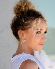 Load image into Gallery viewer, Featuring dainty white rhinestones and dainty marquise-cut iridescent gems, a thin, elongated, airy silver butterfly is titled to the side as if about to take off in flight. A collection of dainty silver rods swings from dainty silver chain tassels at the bottom of the whimsical frame for some free-falling movement. Earring attaches to a standard post fitting. Due to its prismatic palette, color may vary.  Sold as one pair of post earrings.
