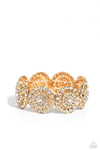 Featuring a wheel motif, concaved gold discs embossed in an explosion of white rhinestones slide along a stretchy band around the wrist for a hint of dazzling refinement. Sold as one individual bracelet.